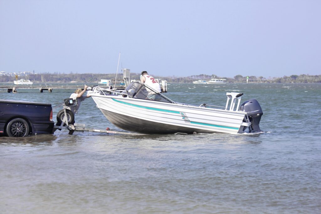 Men launching a boat from the trailer.
