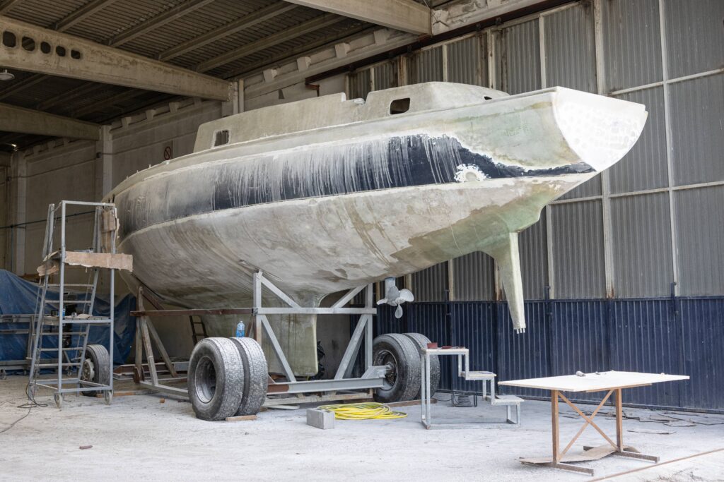 Fiberglass yacht in repair shipyard.